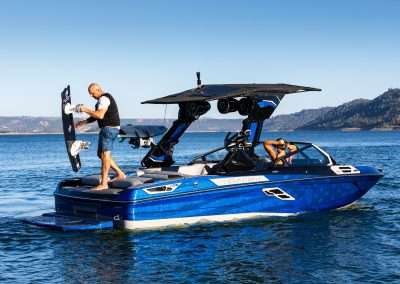Surfer showcasing advanced wakesurf tricks on crystal-clear water